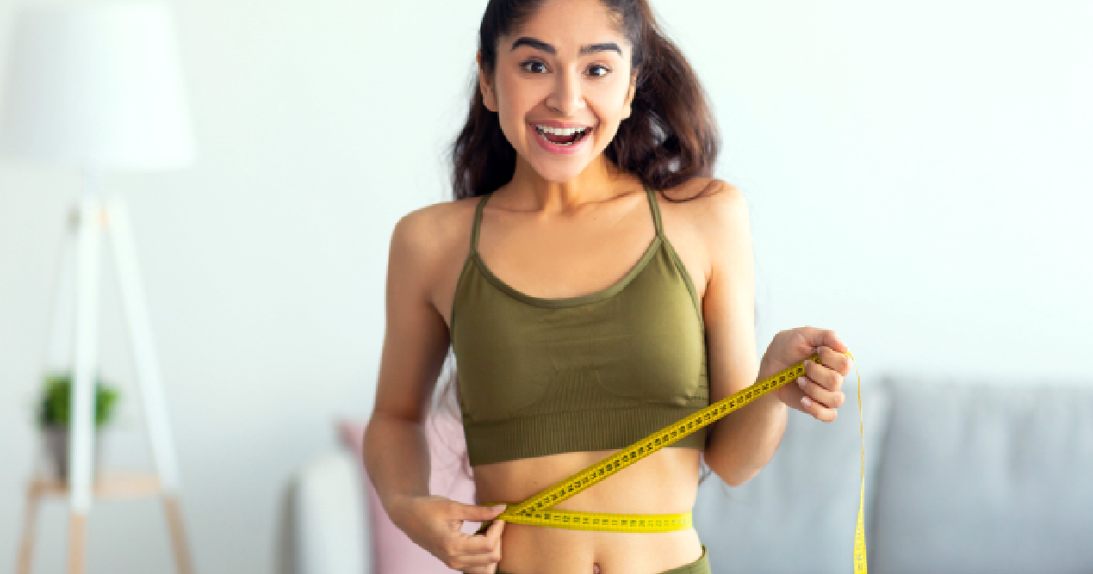 Women checking body measurement after medical weight loss treatment in Addison, TX